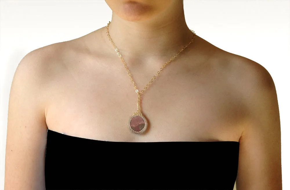 Large round Rhodonite pendant necklace, nested in gold wire crochet