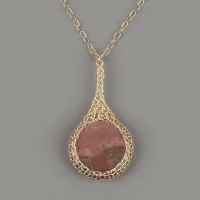 Large round Rhodonite pendant necklace, nested in gold wire crochet