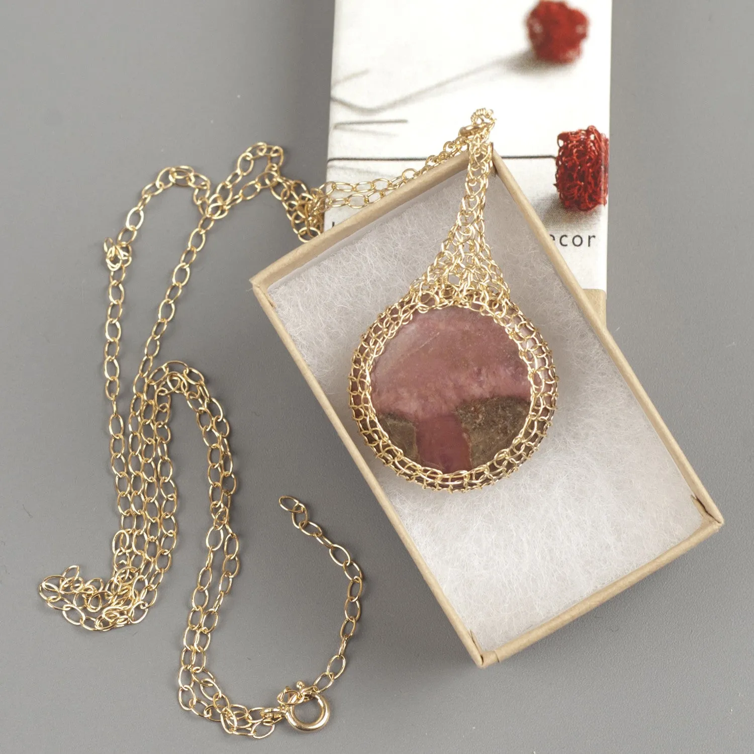 Large round Rhodonite pendant necklace, nested in gold wire crochet