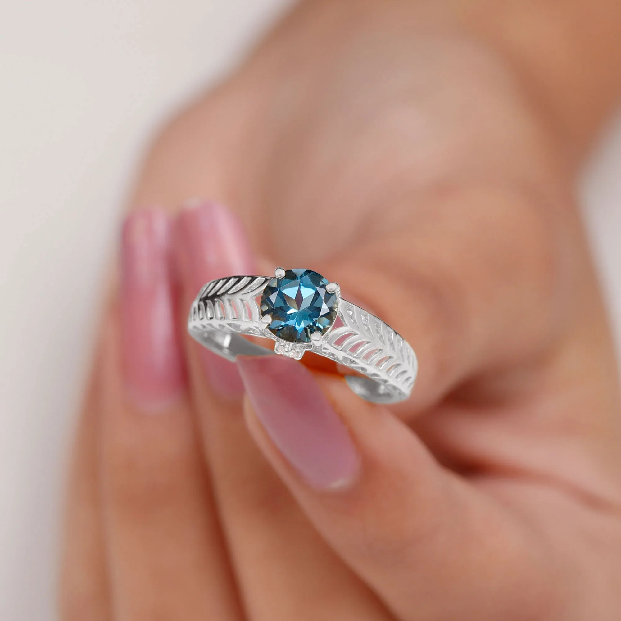 Round London Blue Topaz Solitaire Ring in Cut Out Work