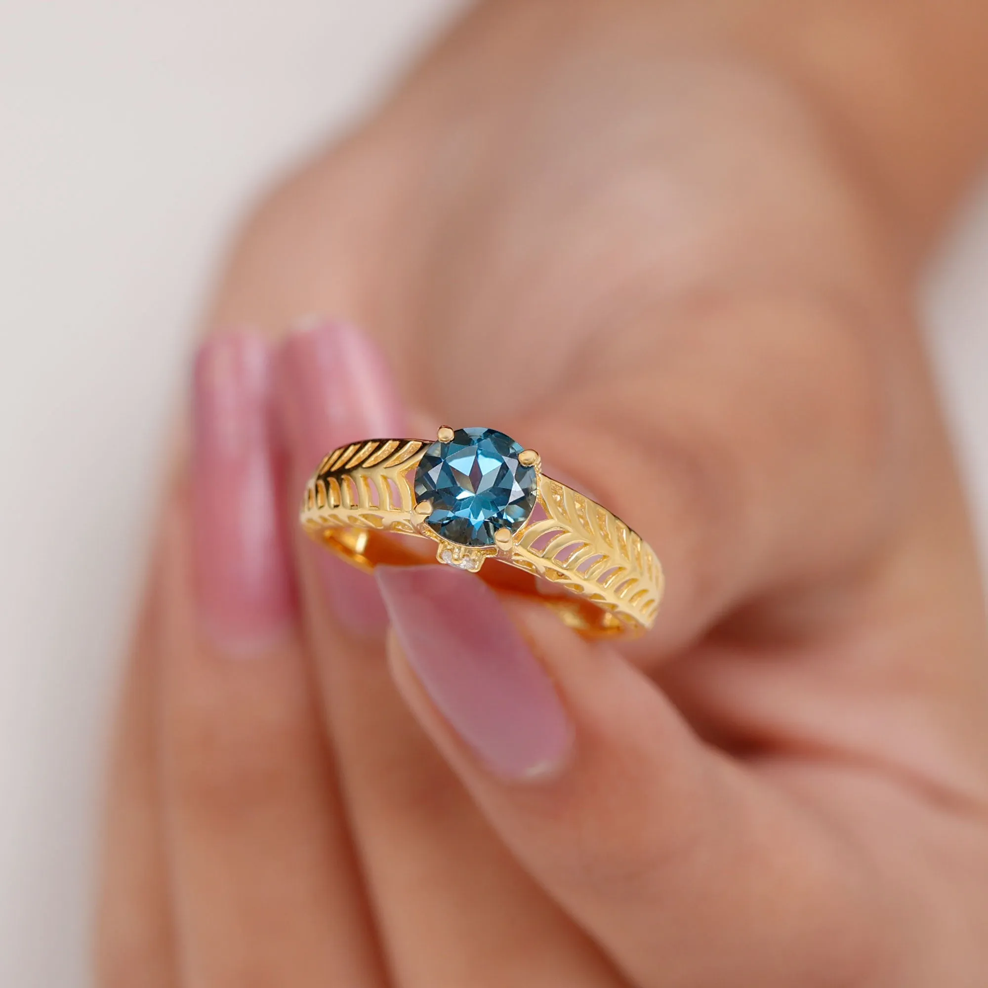 Round London Blue Topaz Solitaire Ring in Cut Out Work